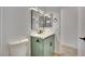 This renovated bathroom features a sage vanity, quartz counters, modern fixtures, and clean bright finishes at 163 Spinnaker Dr, Henderson, NV 89015