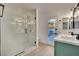 Bright bathroom boasting a glass-enclosed shower, double sink vanity, and access to the backyard at 163 Spinnaker Dr, Henderson, NV 89015