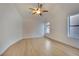 Vaulted ceiling bedroom with light wood flooring, ceiling fan and bright natural light from a large window at 163 Spinnaker Dr, Henderson, NV 89015