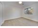 Inviting bedroom featuring fresh white paint, a large window, and comfortable neutral carpeting at 163 Spinnaker Dr, Henderson, NV 89015