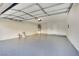 Spacious two-car garage with an epoxy floor and ample storage space for vehicles and tools at 163 Spinnaker Dr, Henderson, NV 89015