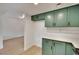 Bright kitchen features stylish green cabinets, stainless steel appliances, and modern countertops at 163 Spinnaker Dr, Henderson, NV 89015