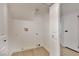 Functional laundry room with hookups and storage space, featuring light wood flooring and clean white walls at 163 Spinnaker Dr, Henderson, NV 89015