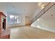 Open-concept living room with hardwood floors, a fireplace, and a staircase at 163 Spinnaker Dr, Henderson, NV 89015
