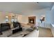 Staged living room featuring hardwood floors, brick fireplace, and neutral-toned furniture at 163 Spinnaker Dr, Henderson, NV 89015