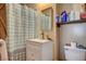 The bathroom is equipped with a vanity, a mirror, and a shower with a curtain at 1808 Walnut Ave, Las Vegas, NV 89101