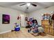 Bedroom with ceiling fan and wood-look tile floors, perfect for a relaxing and comfortable space at 1808 Walnut Ave, Las Vegas, NV 89101