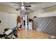 Spacious bedroom with wood-look tile floors, a ceiling fan, and ample storage at 1808 Walnut Ave, Las Vegas, NV 89101