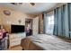 This bedroom has wood-look tile floor, a TV, and a window with a view of the outdoors at 1808 Walnut Ave, Las Vegas, NV 89101