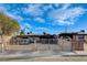 Modest single story home with an expansive gated front yard and covered parking area at 1808 Walnut Ave, Las Vegas, NV 89101