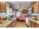 Galley style kitchen and adjacent dining area featuring granite countertops and wood-look tile floors at 1808 Walnut Ave, Las Vegas, NV 89101