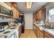 Functional kitchen with wood cabinets, appliances, and laminate flooring at 1808 Walnut Ave, Las Vegas, NV 89101
