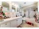 Bright bathroom with white tile, bath/shower combo, and large countertop at 1920 Parkchester Dr, Las Vegas, NV 89108