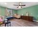 Green bedroom featuring two beds with wooden floors and a ceiling fan at 1920 Parkchester Dr, Las Vegas, NV 89108