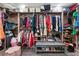 Organized walk-in closet with shelving, hanging rods, and central bench seating at 1920 Parkchester Dr, Las Vegas, NV 89108