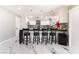 Modern kitchen with sleek white cabinets, black countertops, and trendy barstool seating at 1920 Parkchester Dr, Las Vegas, NV 89108