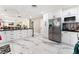 Bright kitchen with stainless steel appliances, white cabinets, and marble floors at 1920 Parkchester Dr, Las Vegas, NV 89108