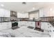 Modern kitchen with white cabinets, stainless steel appliances, black countertops, and stylish backsplash at 1920 Parkchester Dr, Las Vegas, NV 89108