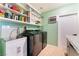 A functional laundry room with modern washer and dryer, sink, and ample shelving at 1920 Parkchester Dr, Las Vegas, NV 89108