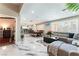 Open-concept living space with marble floors, gray sectional, dining area, and kitchen at 1920 Parkchester Dr, Las Vegas, NV 89108