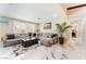 Inviting living room featuring a large gray sectional, marble floors, and natural light at 1920 Parkchester Dr, Las Vegas, NV 89108