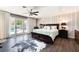 Spacious main bedroom features wood floors, a ceiling fan, and a view to the pool at 1920 Parkchester Dr, Las Vegas, NV 89108