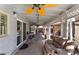 View of the covered patio, with an outdoor lounge area, dining and prep stations and an ornate ceiling fan at 1920 Parkchester Dr, Las Vegas, NV 89108