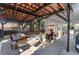 Open-air patio with dining and seating area plus an outdoor kitchen beneath decorative overhead structure at 1920 Parkchester Dr, Las Vegas, NV 89108
