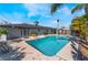 Backyard swimming pool with attached spa and clear blue water, set against the house at 1920 Parkchester Dr, Las Vegas, NV 89108