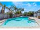 Inviting backyard swimming pool with clear blue water and surrounding lush trees at 1920 Parkchester Dr, Las Vegas, NV 89108