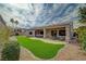 A manicured backyard with patio, synthetic grass, and drought-resistant landscaping at 2602 Evening Sky Dr, Henderson, NV 89052