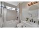 Bathroom featuring a marble vanity, white tile, and a modern soaking tub with shower at 2602 Evening Sky Dr, Henderson, NV 89052
