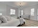 Inviting bedroom with wood-look flooring, white walls, and natural light at 2602 Evening Sky Dr, Henderson, NV 89052