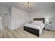 Bedroom with wood-look floors, sliding closet doors, and bright lighting at 2602 Evening Sky Dr, Henderson, NV 89052