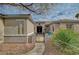 Inviting home entrance with a gated courtyard, stone walkway, desert landscaping, and double doors at 2602 Evening Sky Dr, Henderson, NV 89052