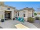 Inviting front exterior with a cozy seating area, desert landscaping, and a stylish double-door entrance at 2602 Evening Sky Dr, Henderson, NV 89052