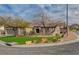 Attractive home featuring desert landscaping, mature trees, and a well-maintained lawn in a suburban setting at 2602 Evening Sky Dr, Henderson, NV 89052