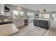 Kitchen featuring stainless appliances, white cabinets and an island with breakfast bar at 2602 Evening Sky Dr, Henderson, NV 89052