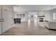 Open-concept living and dining area with wood floors and a modern fireplace at 2602 Evening Sky Dr, Henderson, NV 89052