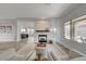 Bright living room with a modern fireplace, neutral decor, and sliding doors to the outdoor space at 2602 Evening Sky Dr, Henderson, NV 89052