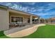 Covered patio with dining table and seating area overlooking the lawn at 2602 Evening Sky Dr, Henderson, NV 89052
