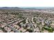 A wide aerial view of a residential neighborhood in a desert environment, showcasing community layout and local roadways at 3047 Whispering Crest Dr, Henderson, NV 89052