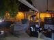 This cozy outdoor space is perfect for relaxing with accent lighting, mature landscaping and a grill at 3047 Whispering Crest Dr, Henderson, NV 89052