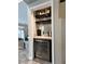 Stylish bar area with modern finishes, wine cooler, and ample storage for spirits and glassware at 3047 Whispering Crest Dr, Henderson, NV 89052