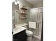 Bright bathroom featuring a modern vanity, floating shelves, and a glass-enclosed shower at 3047 Whispering Crest Dr, Henderson, NV 89052