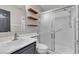 Well-lit bathroom features a glass-enclosed shower, single sink vanity and floating shelves for extra storage at 3047 Whispering Crest Dr, Henderson, NV 89052