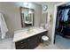 Bathroom features a vanity with a makeup area, a walk-in closet, and a wall-mounted mirror at 3047 Whispering Crest Dr, Henderson, NV 89052
