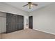 Carpeted bedroom with black closet doors and ceiling fan at 3047 Whispering Crest Dr, Henderson, NV 89052
