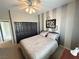 Bedroom featuring a double bed, closet with black doors, ceiling fan, and stylish wall decor at 3047 Whispering Crest Dr, Henderson, NV 89052