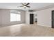Bedroom featuring wood floors, a ceiling fan, and a large window that allows plenty of natural light at 3047 Whispering Crest Dr, Henderson, NV 89052